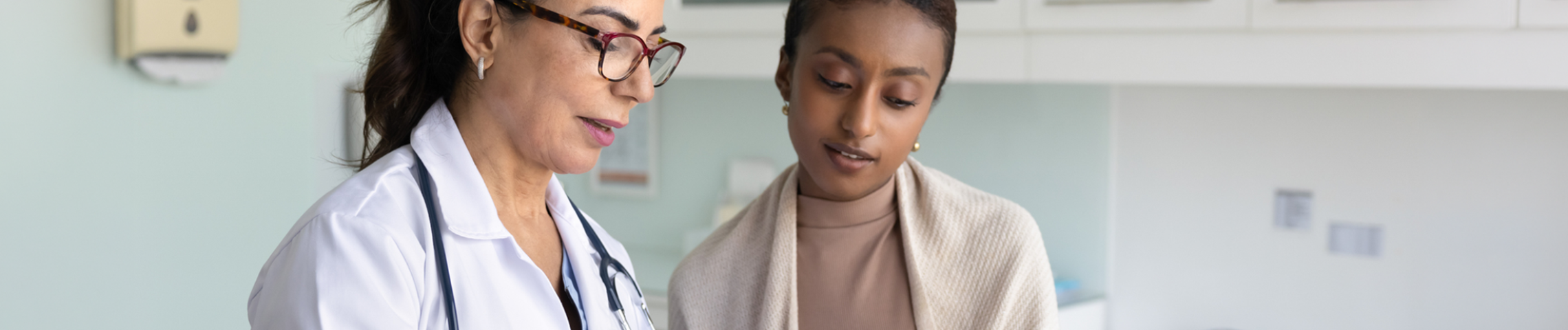 Doctor and patient reviewing tablet together