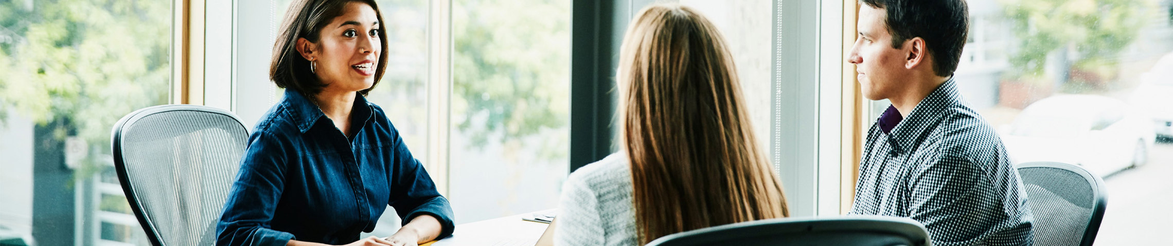 Three people having a meeting in an office