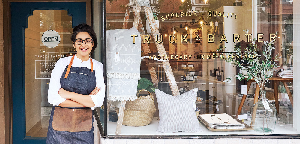 Smiling shop owner outside boutique	