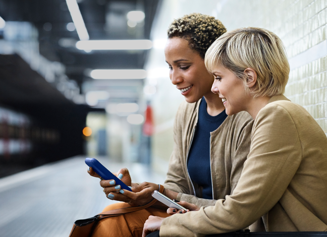 Women talking at train station