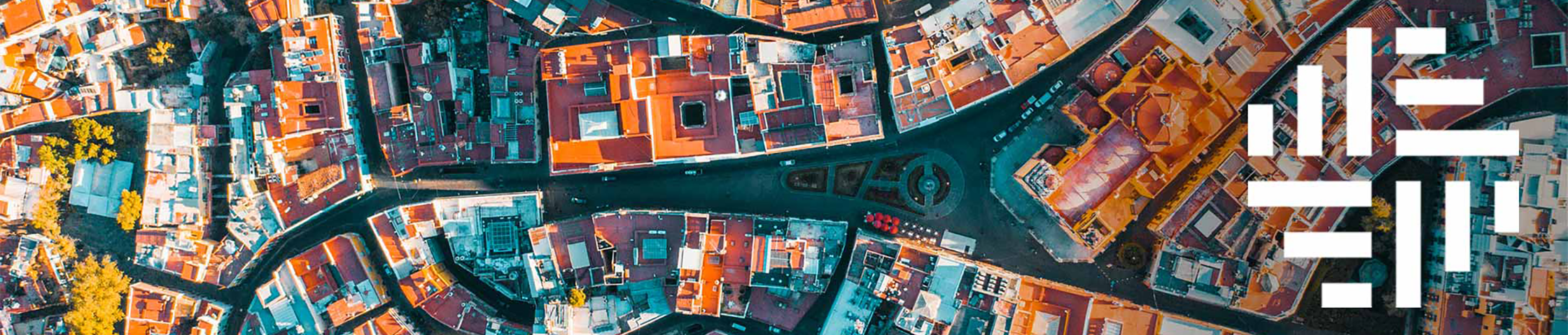 Aerial view of city rooftops and streets