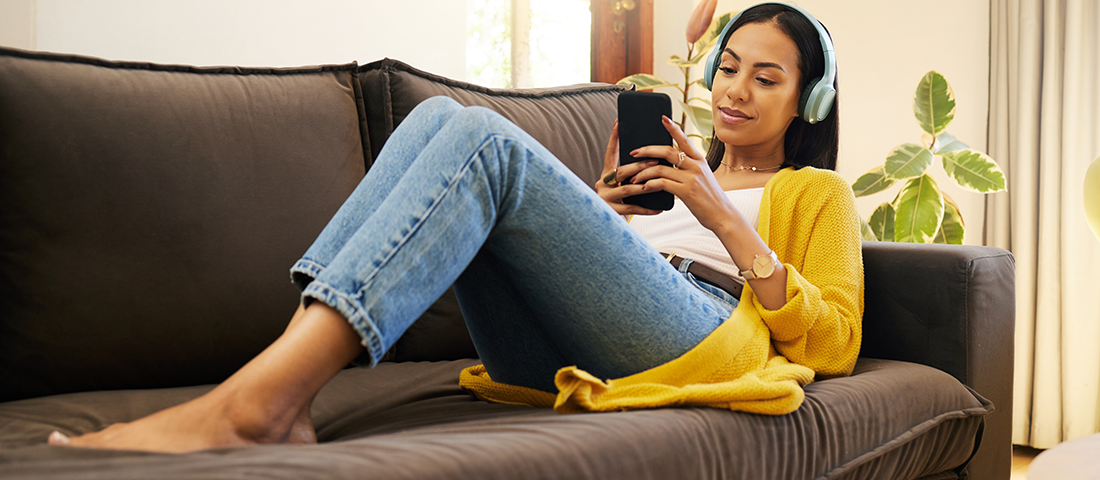 Woman relaxing on couch with headphones